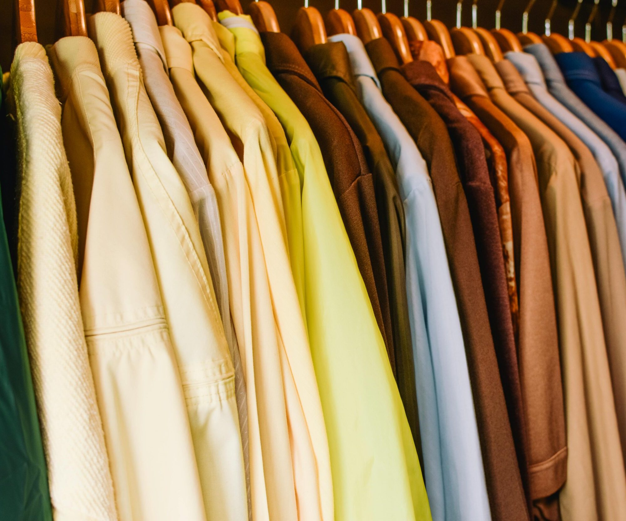 A vibrant selection of shirts and jackets in a wardrobe, perfect for fashion concepts.